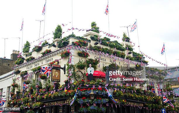 The Churchill Arms pub is decorated as part of a street party in Kensington during the Queen's Diamond Jubilee celebrations on June 4, 2012 in...