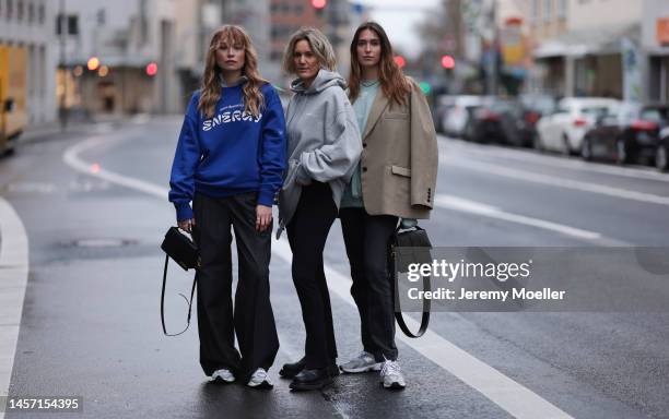 Nadine Berneis seen wearing a black Jacqemus handbag, black P&C x Ann- Kathrin Götze pants, a blue HERNAMEIS the label sweater and New Balance 9060...