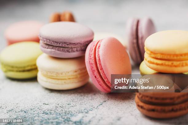 macaroni cookies of different colors in a box on a gray textured background made of stone free space,romania - macaroon stock pictures, royalty-free photos & images