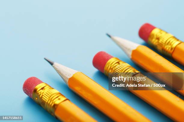 orange pencils with an eraser on a blue background,romania - yellow pencil stock pictures, royalty-free photos & images