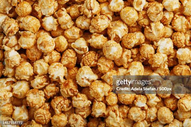 popcorn in caramel glaze close-up as a background,romania - caramel popcorn stock pictures, royalty-free photos & images
