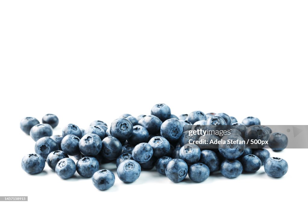 Tasty blueberries fruit are scattered on a white background,Romania