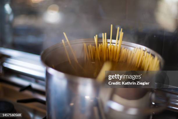 close-up of spaghetti boiling in a pot - boiling pasta stock pictures, royalty-free photos & images