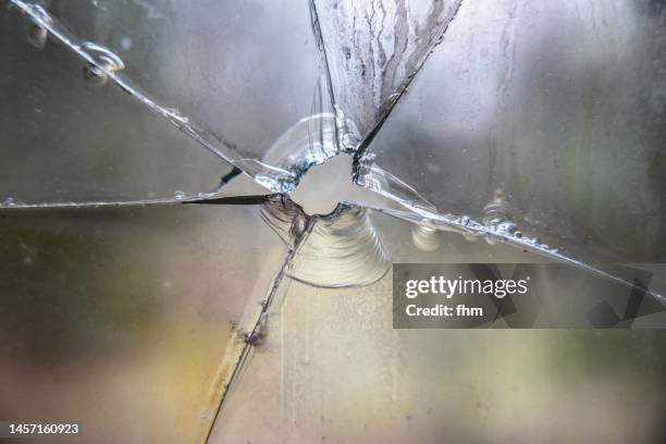 shattered glass after a pistol shot - crime and murder stock-fotos und bilder