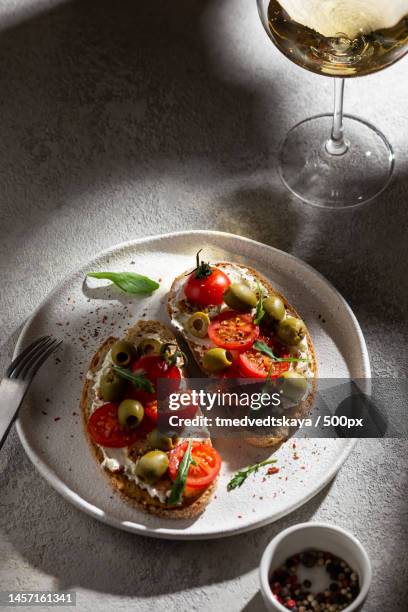 plate with bruschettas and glass of wine,russia - bruschetta foto e immagini stock