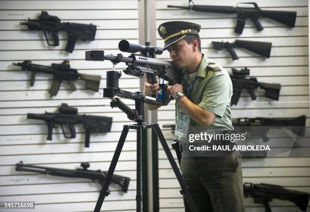 Colombian police officer shows a Barrett M95 .50 caliber sniper rifle being displayed during the 10th Regional Conference of the International...