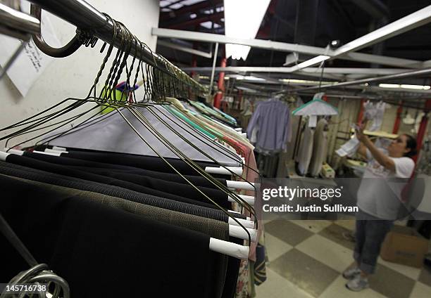 Freshly pressed pants hang on wire hangers at Maxwell the Cleaner on June 4, 2012 in San Rafael, California. Dry cleaning prices are on the rise as...