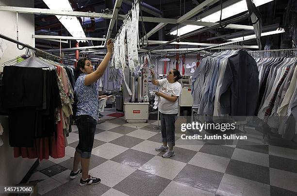 Workers at Maxwell the Cleaner sort freshly pressed shirts on June 4, 2012 in San Rafael, California. Dry cleaning prices are on the rise as the cost...