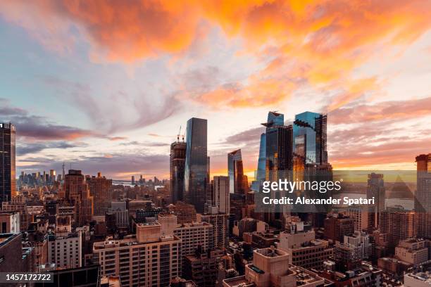 dramatic colorful sunset above hudson yards and manhattan, new york usa - hudson yards stock pictures, royalty-free photos & images