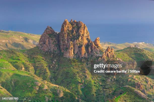 scenic view of rocks and sea against sky,pentidattilo,reggio calabria,italy - reggio calabria foto e immagini stock