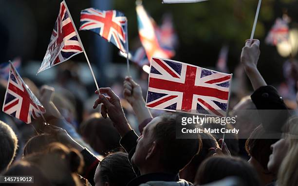 Diamond Jubilee revelers wave the Union Jack flag in the Mall during the entertainment at the Buckingham Palace Concert on June 4, 2012 in London,...