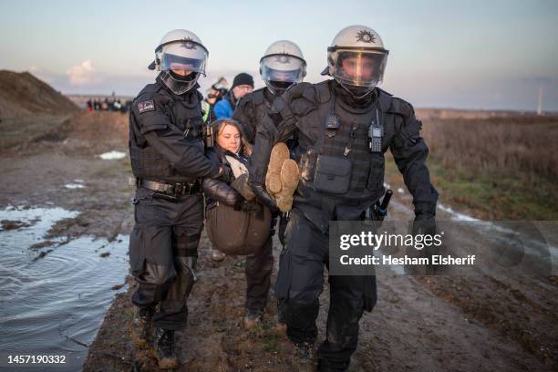 Police officers detain climate activist Greta Thunberg at a demonstration against the expansion of the Garzweiler coal mine near the village of...