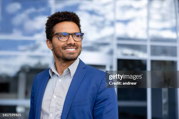 portrait of a happy business man outside an office building - looking away stock pictures, royalty-free photos & images