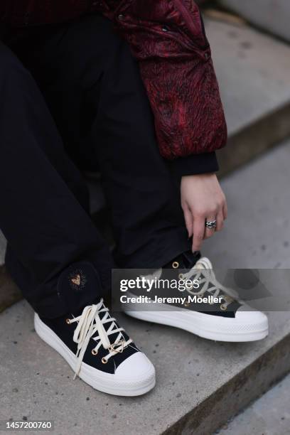 Kiwi wearing Converse high sneaker, black wide trousers during the Berlin Fashion Week AW23 on January 16, 2023 in Berlin, Germany.