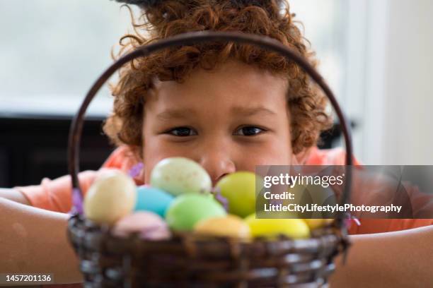 boy and his easter basket full of eggs - easter eggs basket bildbanksfoton och bilder