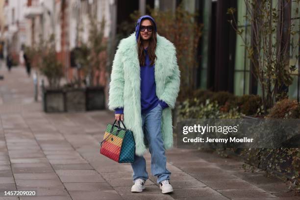 Riccardo Simonetti seen wearing Gucci green yellow and red bag and white Gucci sneaker, Tom Ford brown round shades, H&M Metaverse fur collection...