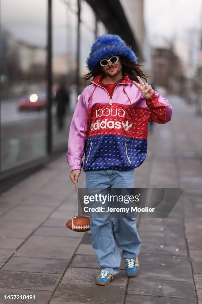 Riccardo Simonetti seen wearing Gucci x Adidas blue sneaker & Gucci x Adidas pink red and blue basketball jacket, Carhartt denim blue jeans, Acne...