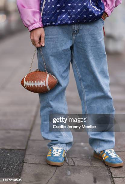 Riccardo Simonetti seen wearing Gucci x Adidas blue sneaker & Gucci x Adidas pink red and blue basketball jacket, Carhartt denim blue jeans, Acne...