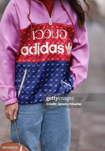 Riccardo Simonetti seen wearing Gucci x Adidas blue sneaker & Gucci x Adidas pink red and blue basketball jacket, Carhartt denim blue jeans, Acne...