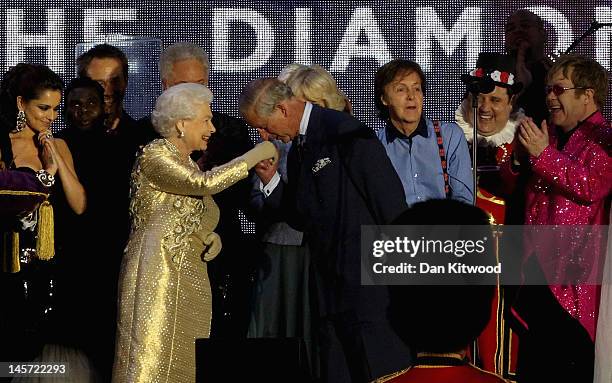Queen Elizabeth II and The Prince of Wales on stage with artists during the Diamond Jubilee concert at Buckingham Palace on June 4, 2012 in London,...