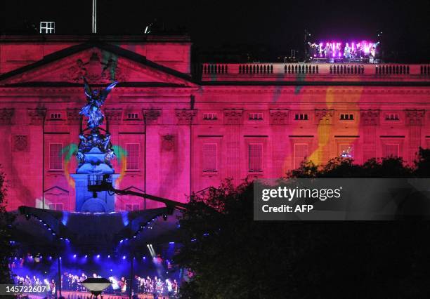 Buckingham Palace is illuminated as British band 'Madness' perform on the roof of the Palace at the Diamond Jubilee Concert in London, on June 4,...