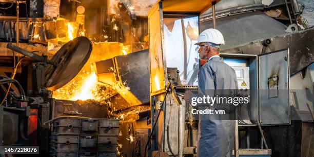 portrait of senior man standing in metallurgy plant - old factory stock pictures, royalty-free photos & images