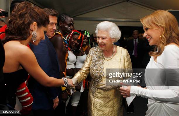 Queen Elizabeth II is introduced to Cheryl Cole by Kylie Minogue backstage after the Diamond Jubilee, Buckingham Palace Concert on June 04, 2012 in...
