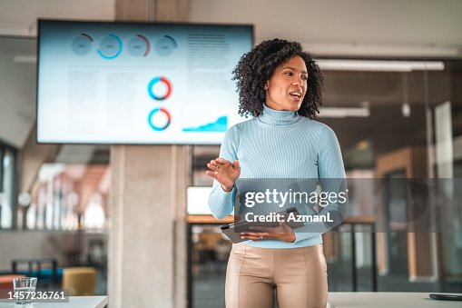Portrait of a Good Looking Woman Giving a Speech Using Technology Portrait of a Good Looking Woman Giving a Speech Using Technology