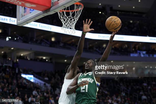 Jrue Holiday of the Milwaukee Bucks drives to the basket against O.G. Anunoby of the Toronto Raptors during the first half of a game at Fiserv Forum...