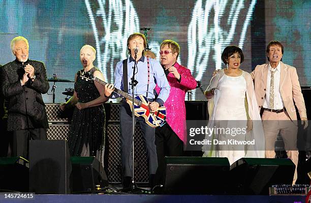 Musician Sir Paul McCartney performs on stage with Sir Tom Jones, Annie Lennox, Sir Elton John, Dame Shirley Bassey and Sir Cliff Richard during the...