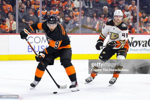 Ivan Provorov of the Philadelphia Flyers skates with the puck past Max Jones of the Anaheim Ducks during the third period at Wells Fargo Center on...
