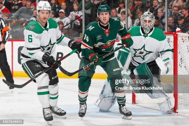 Jake Oettinger and Colin Miller of the Dallas Stars defend against Sammy Walker of the Minnesota Wild during the game at the Xcel Energy Center on...