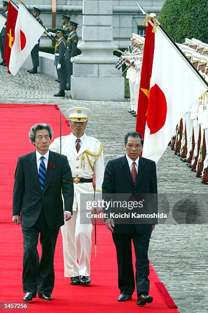 Vietnamese Communist Party General Secretary Nong Duc Manh and Japanese Prime Minister Junichiro Koizumi walk together during a welcome ceremony at...