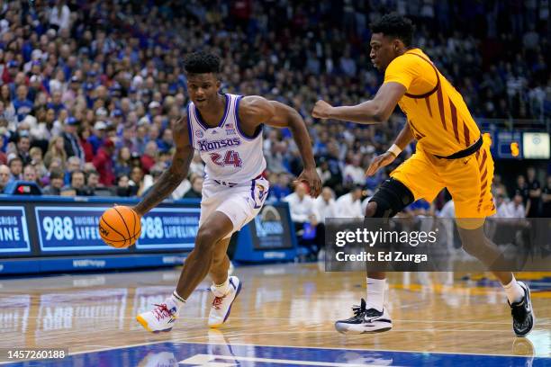 Adams Jr. #24 of the Kansas Jayhawks drives against Osun Osunniyi of the Iowa State Cyclones at Allen Fieldhouse on January 14, 2023 in Lawrence,...