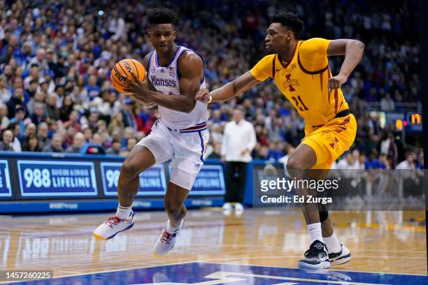 Adams Jr. #24 of the Kansas Jayhawks drives against Osun Osunniyi of the Iowa State Cyclones at Allen Fieldhouse on January 14, 2023 in Lawrence,...