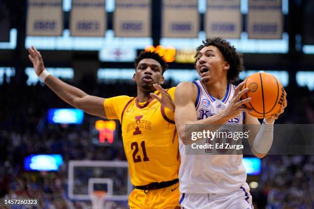 Jalen Wilson of the Kansas Jayhawks drives to the basket against Osun Osunniyi of the Iowa State Cyclones at Allen Fieldhouse on January 14, 2023 in...