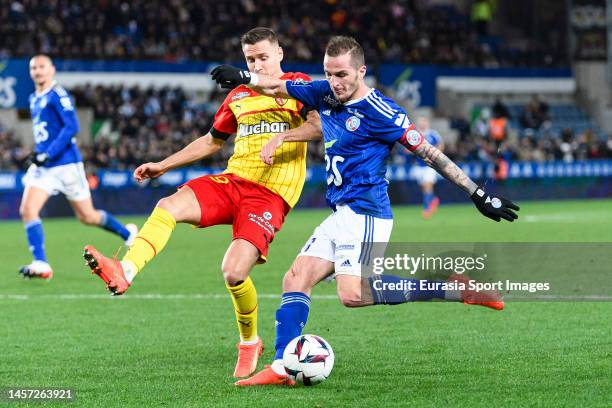 Dimitri Lienard of RC Strasbourg attempts a kick while being defended by Przemyslaw Frankowski of Lens during the Ligue 1 match between RC Strasbourg...