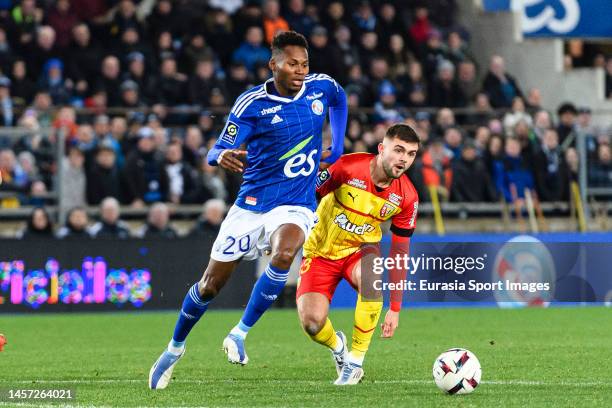 Habib Diallo of RC Strasbourg dribbles Lukasz Poreba of Lens during the Ligue 1 match between RC Strasbourg and RC Lens at Stade de la Meinau on...