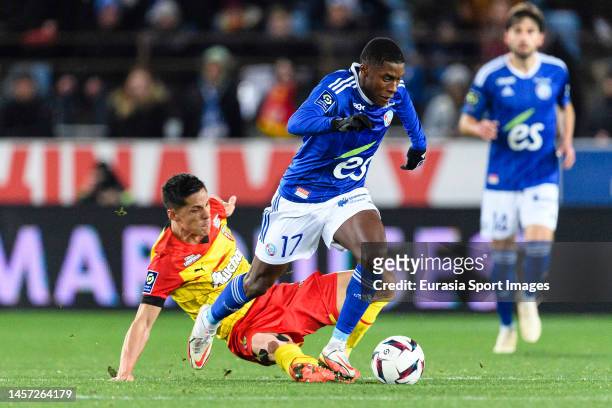 Florian Sotoca of Lens fights for the ball with Jean-Ricner Bellegarde of RC Strasbourg during the Ligue 1 match between RC Strasbourg and RC Lens at...