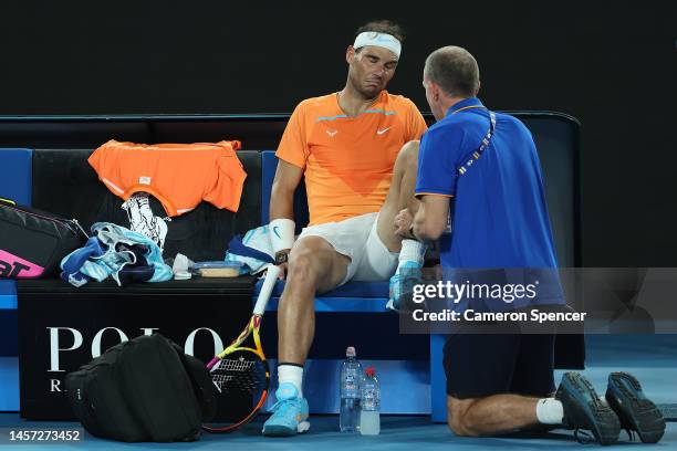 Rafael Nadal of Spain receives attention during a medical time out in their round two singles match against Mackenzie McDonald of the United States...