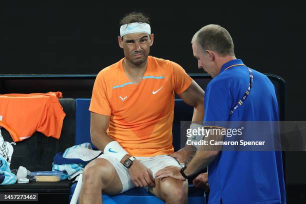 Rafael Nadal of Spain receives attention during a medical time out in their round two singles match against Mackenzie McDonald of the United States...