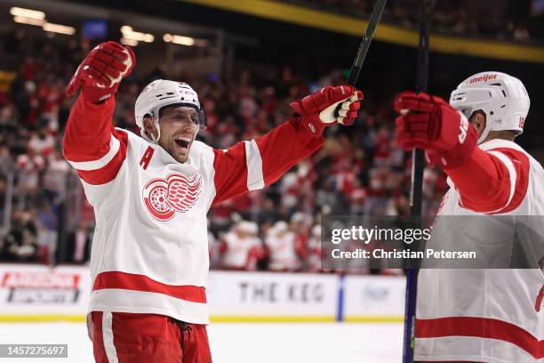 David Perron of the Detroit Red Wings celebrates with Andrew Copp after scoring a goal against the Arizona Coyotes during the third period of the NHL...