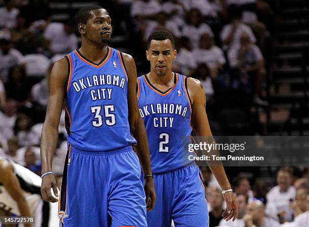 Kevin Durant and Thabo Sefolosha of the Oklahoma City Thunder look on against the San Antonio Spurs in Game Five of the Western Conference Finals of...