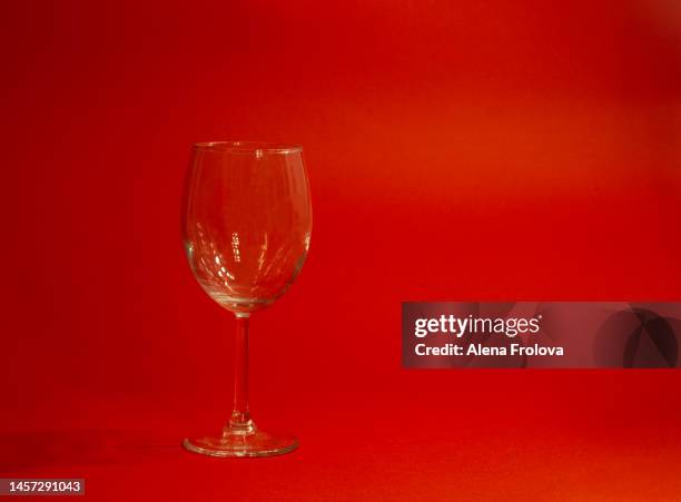 empty glass on red background - january stock pictures, royalty-free photos & images