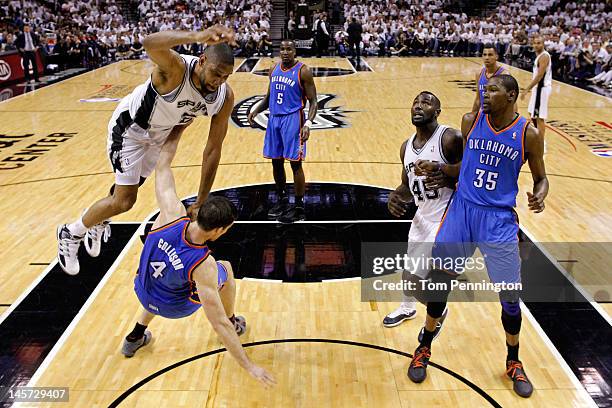 Nick Collison of the Oklahoma City Thunder draws the charge against Tim Duncan of the San Antonio Spurs as DeJuan Blair and Kevin Durant fight for...