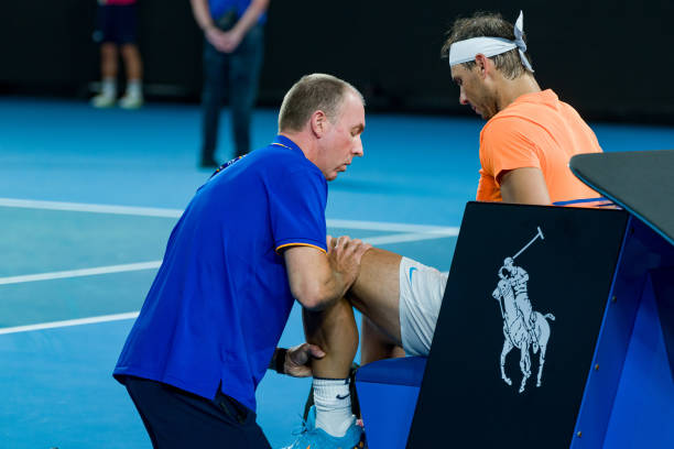 Rafael Nadal of Spain receives medical attention in the round two singles match against Mackenzie McDonald of the United States during day three of...