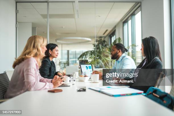 multiracial team of female and male professionals in meeting - meeting board room stock pictures, royalty-free photos & images