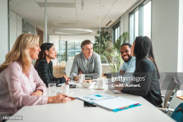 successful mid adult ceos meeting in international corporation - table discussion stock pictures, royalty-free photos & images