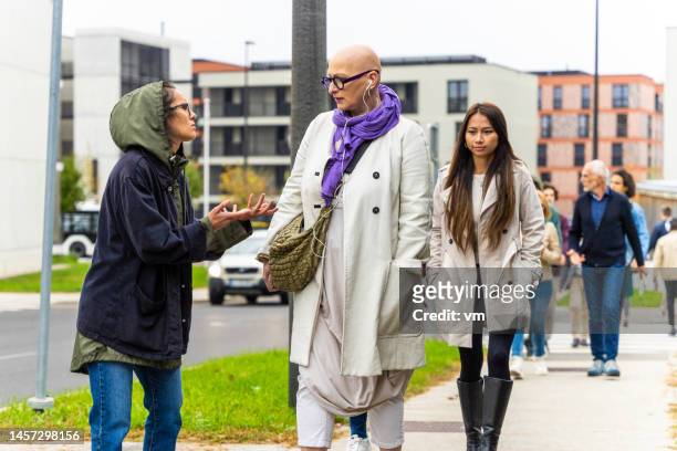 young woman stopping caucasian mud adult person and asking for help in city - asking money stock pictures, royalty-free photos & images