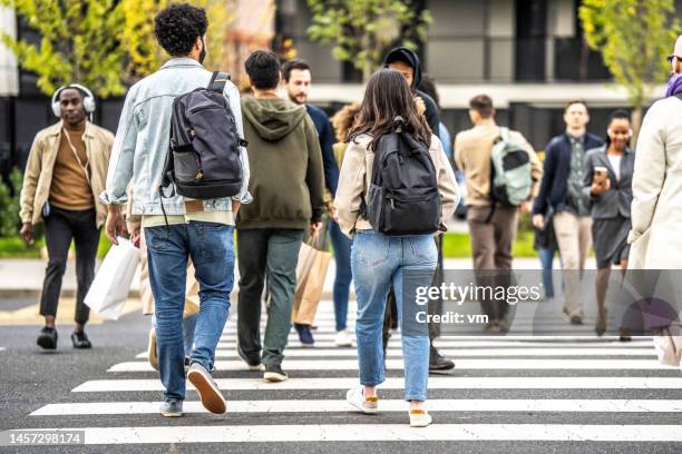 citizens crossing crowded zebra, wide shot - pedestrians walking stock pictures, royalty-free photos & images